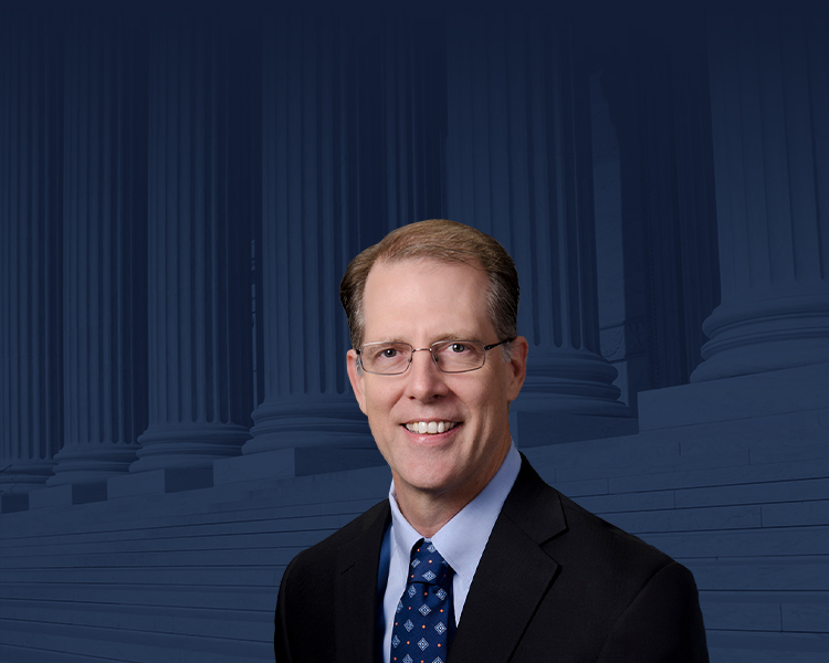 William T. McKinley with a photograph of the Supreme Court of the United States with a blue filter in the background.